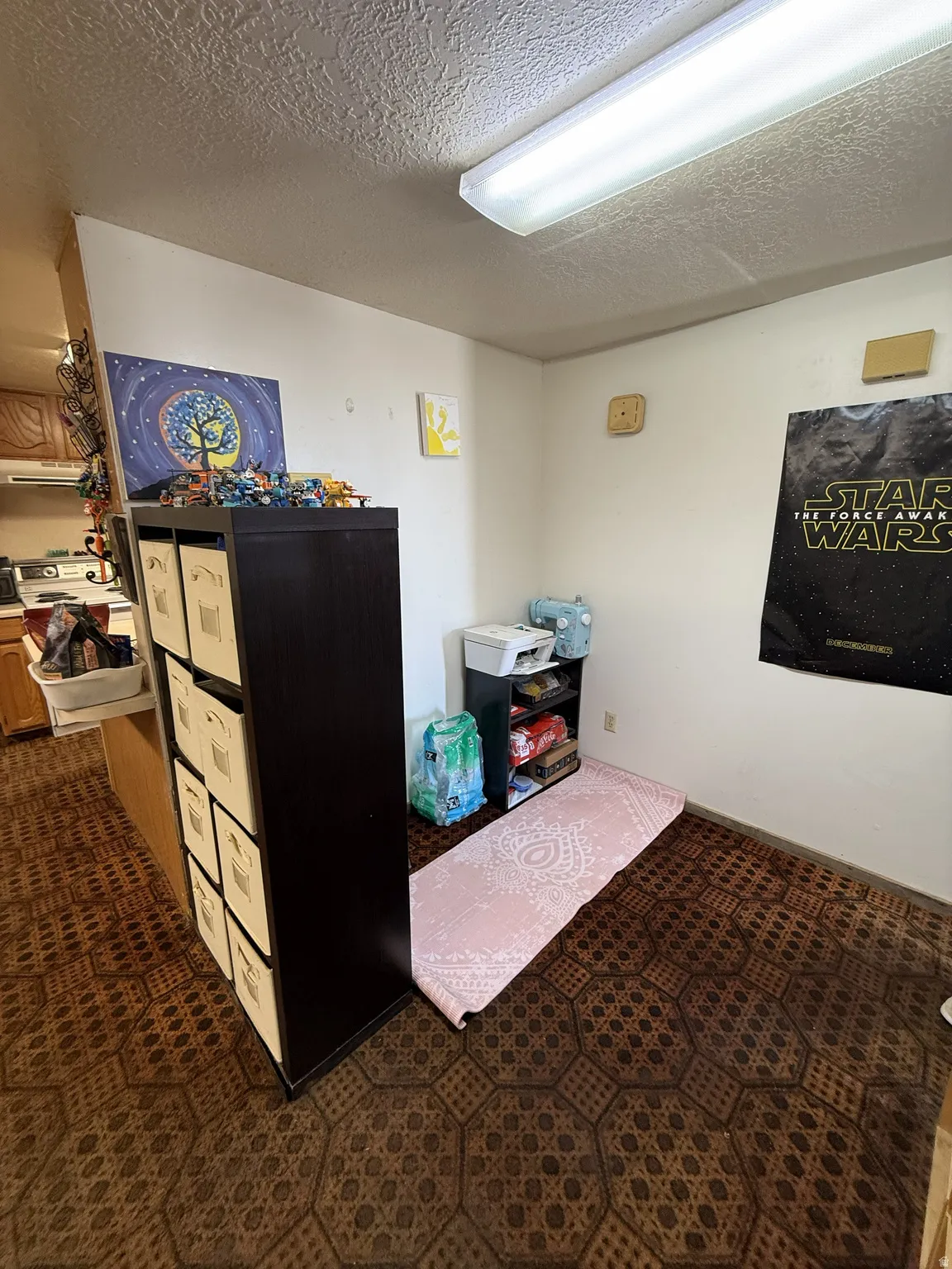 Compact interior space featuring patterned flooring and white walls