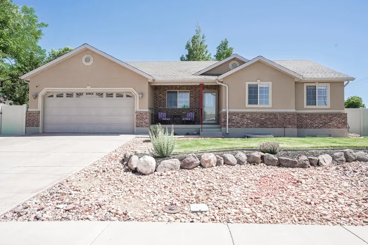 Ranch-style exterior featuring stucco and brick accents