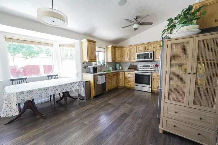 Kitchen featuring wood cabinetry, stainless steel appliances, and a tiled backsplash