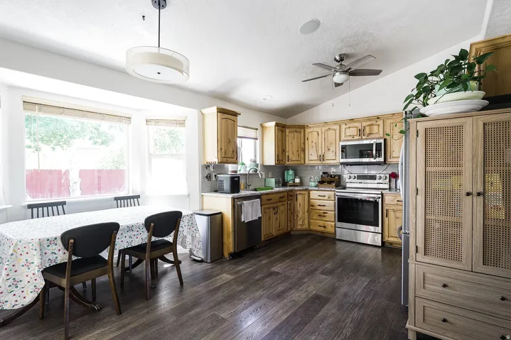Spacious kitchen featuring wood-finish cabinetry, stainless steel appliances, and a tile backsplash