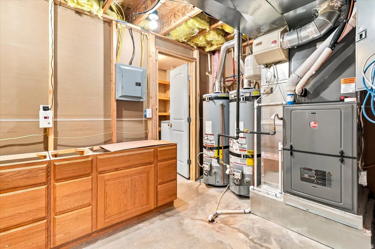 Utility area featuring two water heaters, a new furnace.