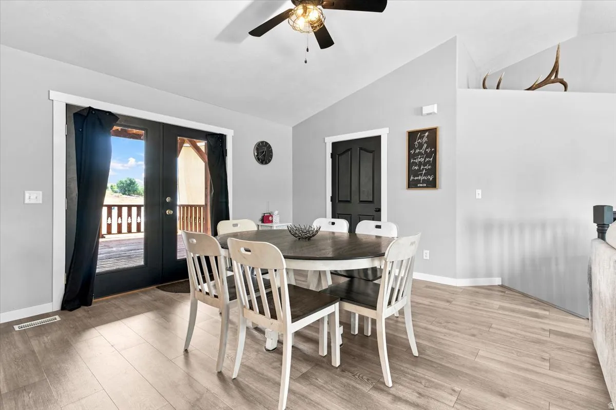 Dining area featuring wood-finish flooring and a ceiling fan