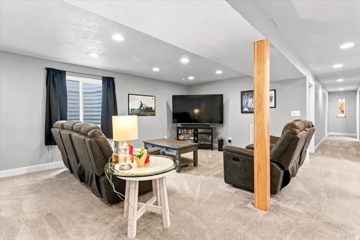 Finished lower level featuring recessed lighting, and new carpet flooring throughout.