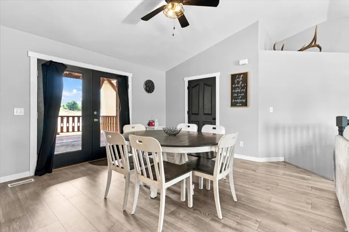 Dining area featuring wood-finish flooring and a ceiling fan