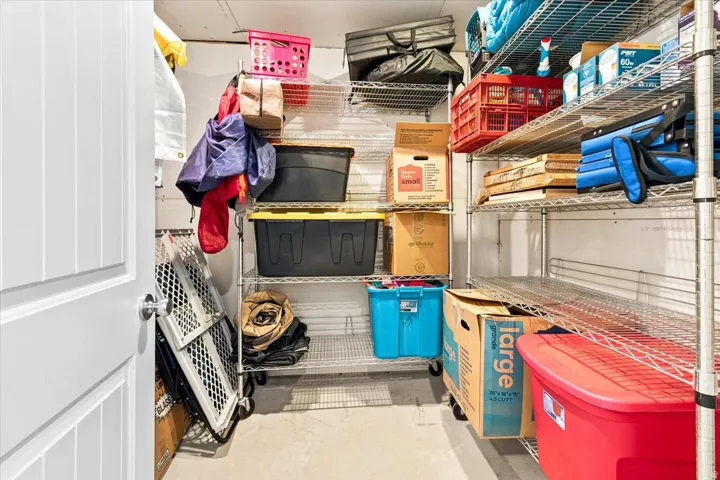 Dedicated storage area featuring concrete flooring and extensive wire shelving