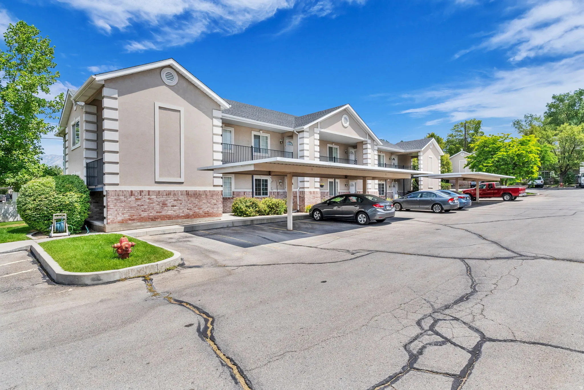 Multi-unit building featuring stucco and brick veneer siding