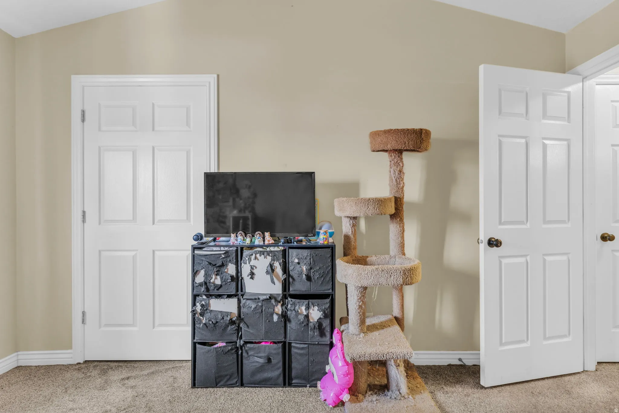 Interior space featuring a vaulted ceiling and neutral wall paint