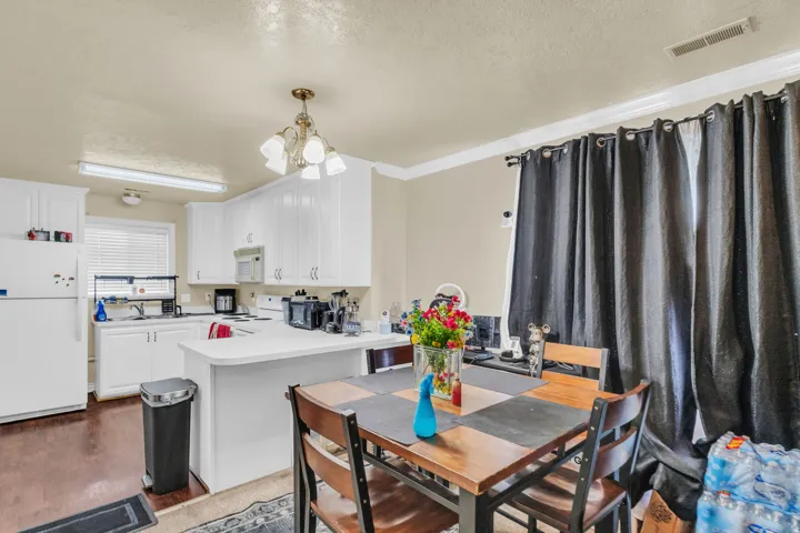 Open-concept kitchen and dining area featuring wood-finish flooring