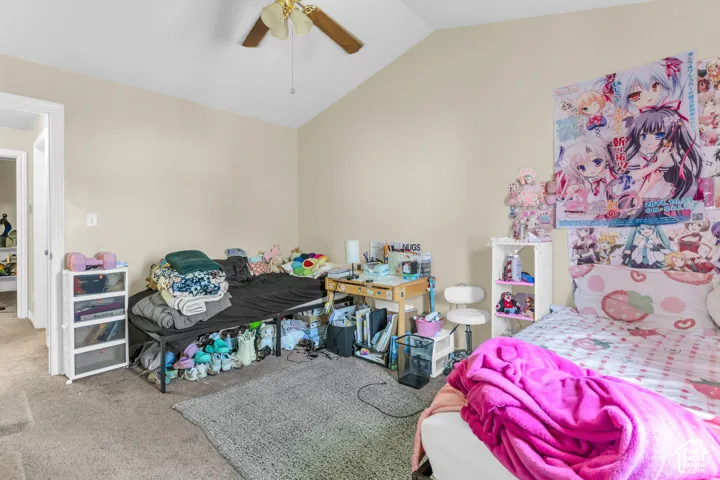 Interior room featuring a vaulted ceiling with a ceiling fan