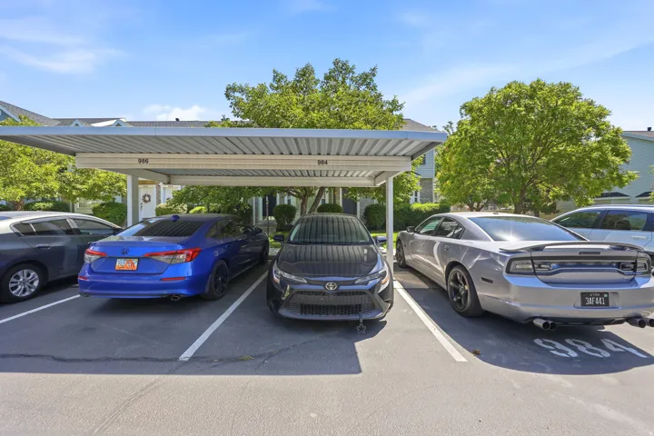 Covered parking structure featuring numbered spaces and a metal roof