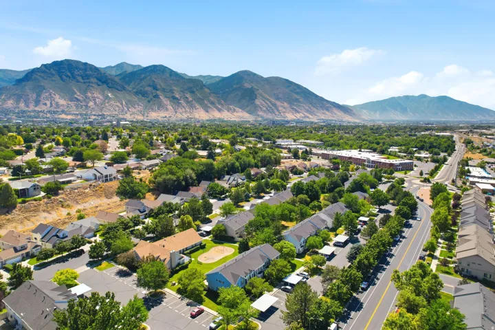 Expansive aerial perspective showcasing a residential community nestled against a mountainous backdrop