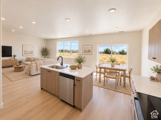 Open-concept living space featuring wood-finish flooring, recessed lighting, and large windows