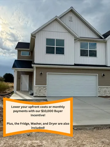 Two-story exterior with a two-car garage, horizontal siding, vertical siding, and stone accents