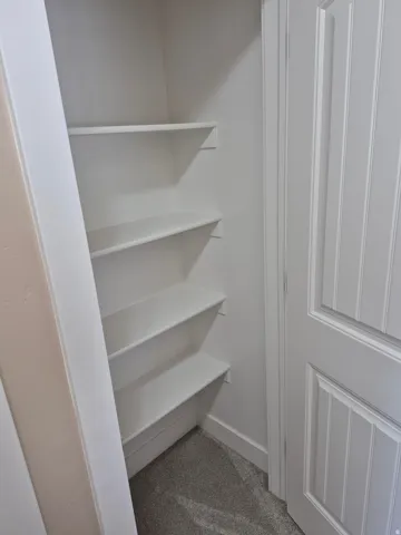 Interior closet with five white shelves