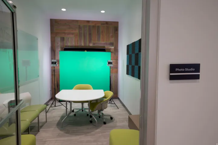 Dedicated "Photo Studio" space featuring a distressed wood-finish accent wall, acoustic paneling, and recessed lighting