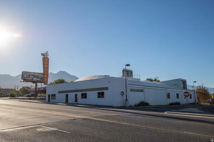Commercial building with a flat roofline, multiple window openings, and a light-colored exterior finish