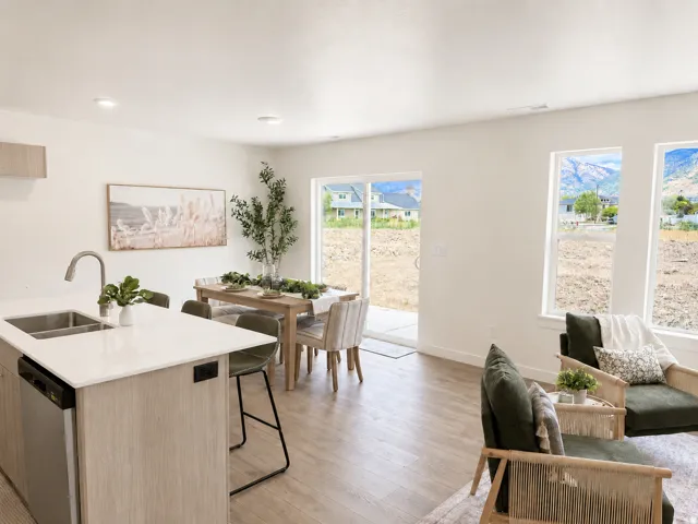 Open-concept living space featuring wood-finish flooring, recessed lighting, and a sliding glass door