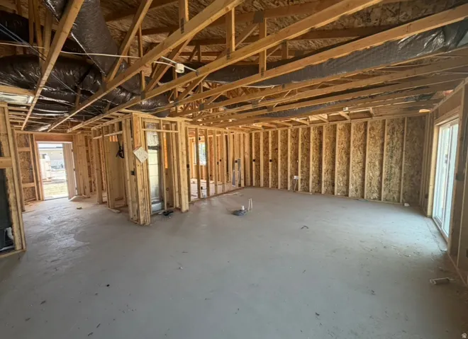 New construction framing on concrete slab, and a sliding glass door