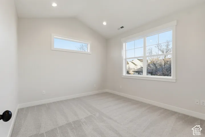 Light gray carpeting, white baseboards, and neutral wall tones define this room
