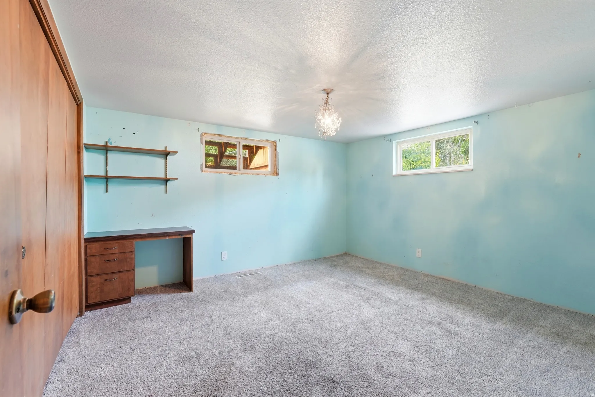 Room featuring carpeted flooring and light blue walls