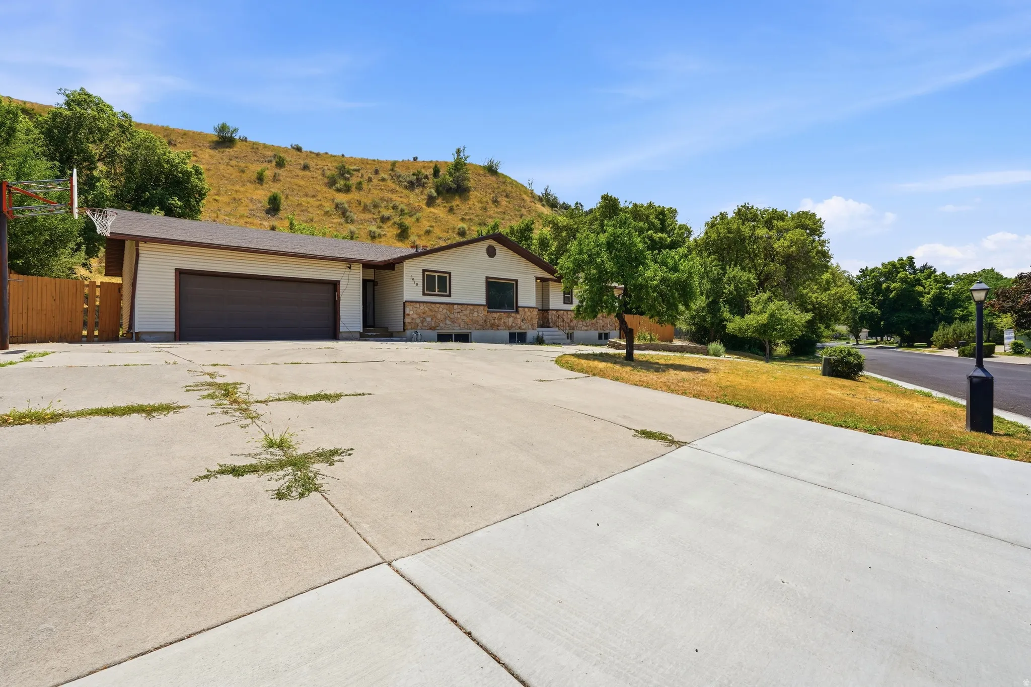 Ranch-style exterior with a two-car garage and a stone facade accent