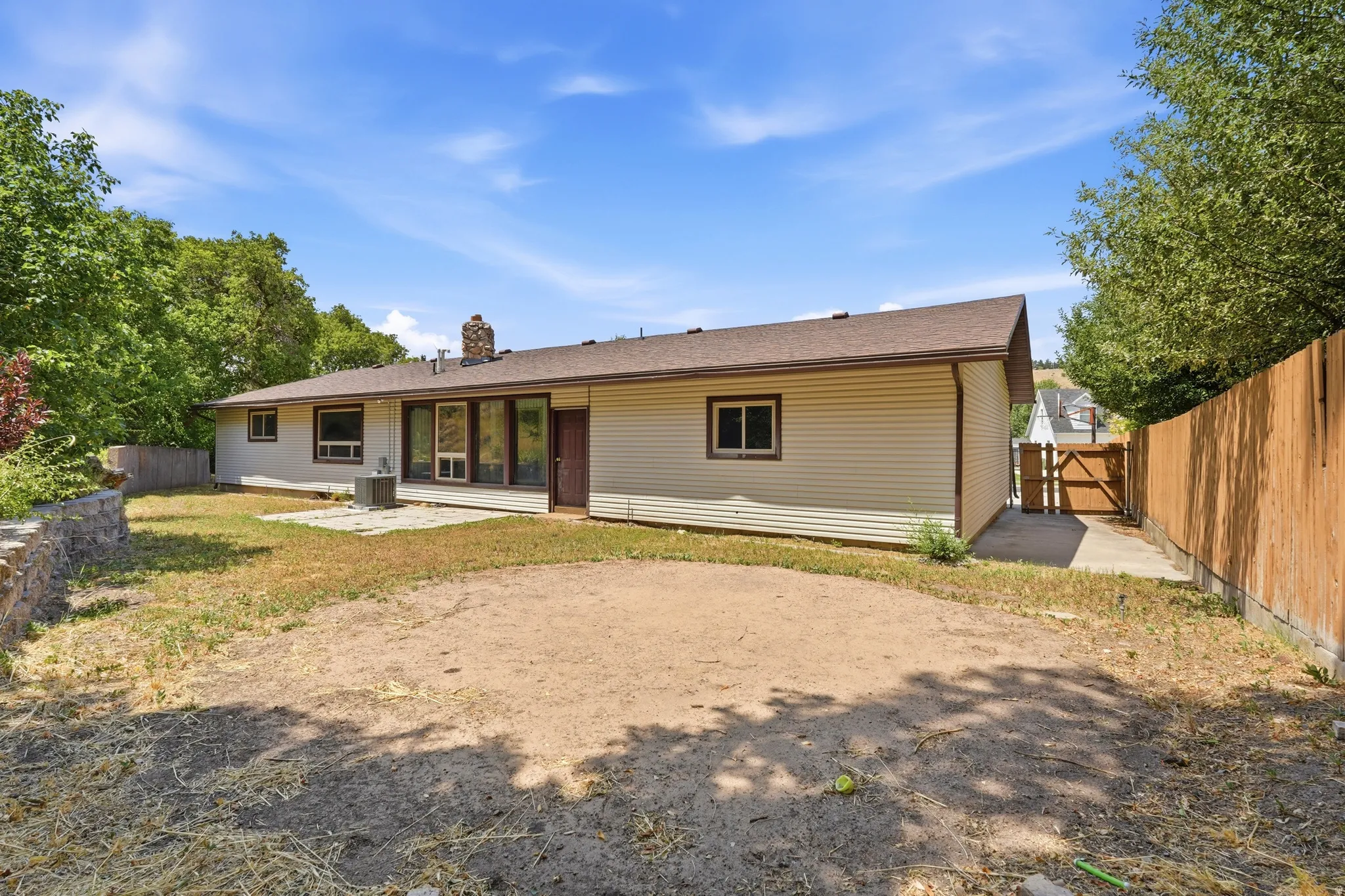Ranch-style exterior with beige horizontal siding and a brown shingle roof