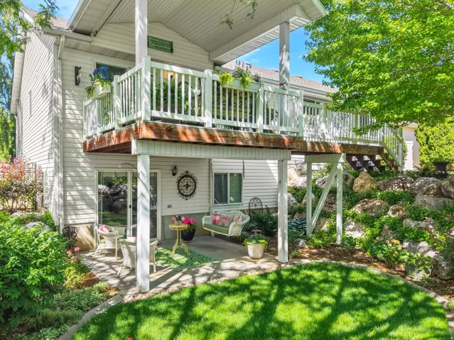 Multi-level exterior featuring a ground-level patio and an upper-level deck