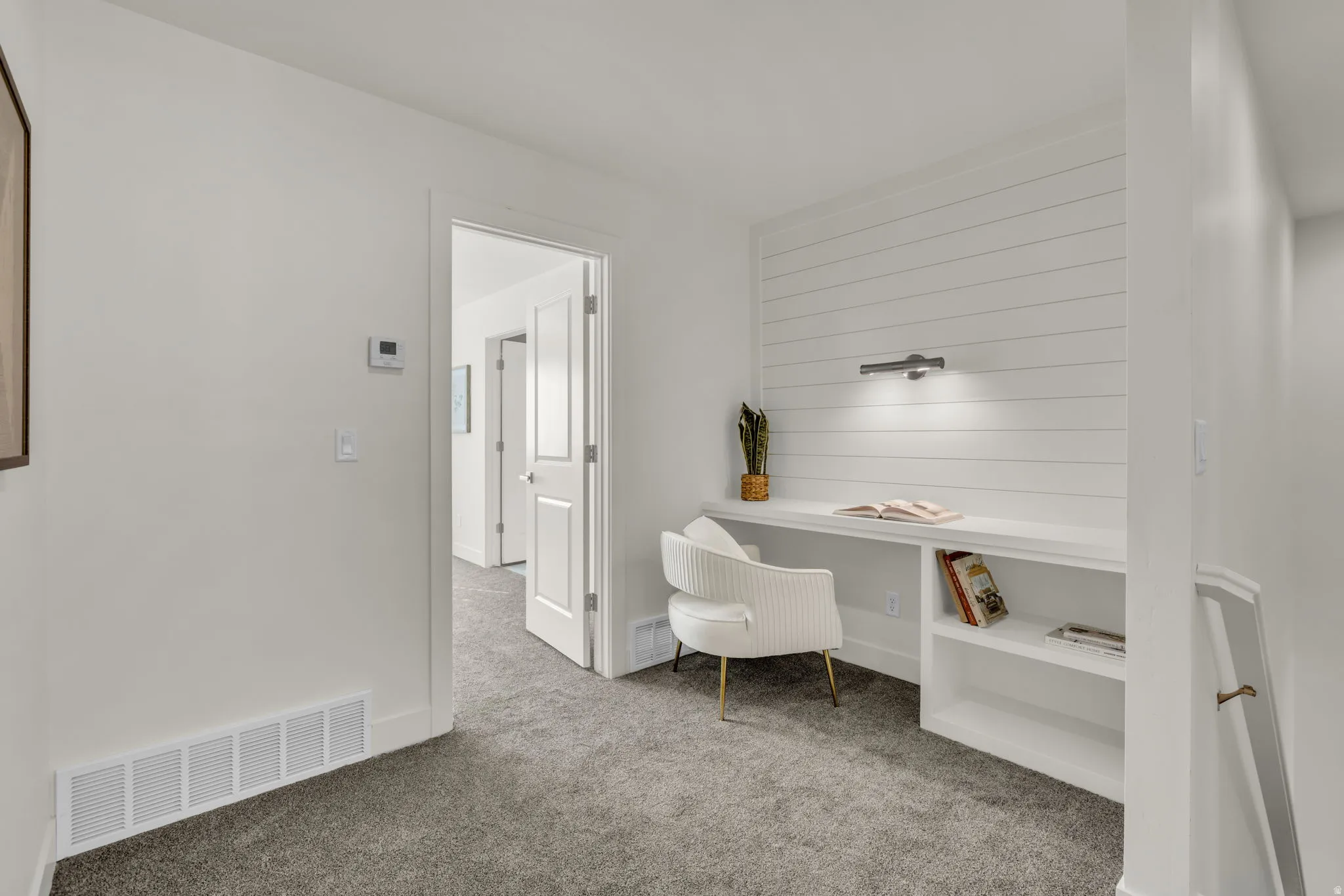 Integrated built-in desk with shelving and shiplap accent wall