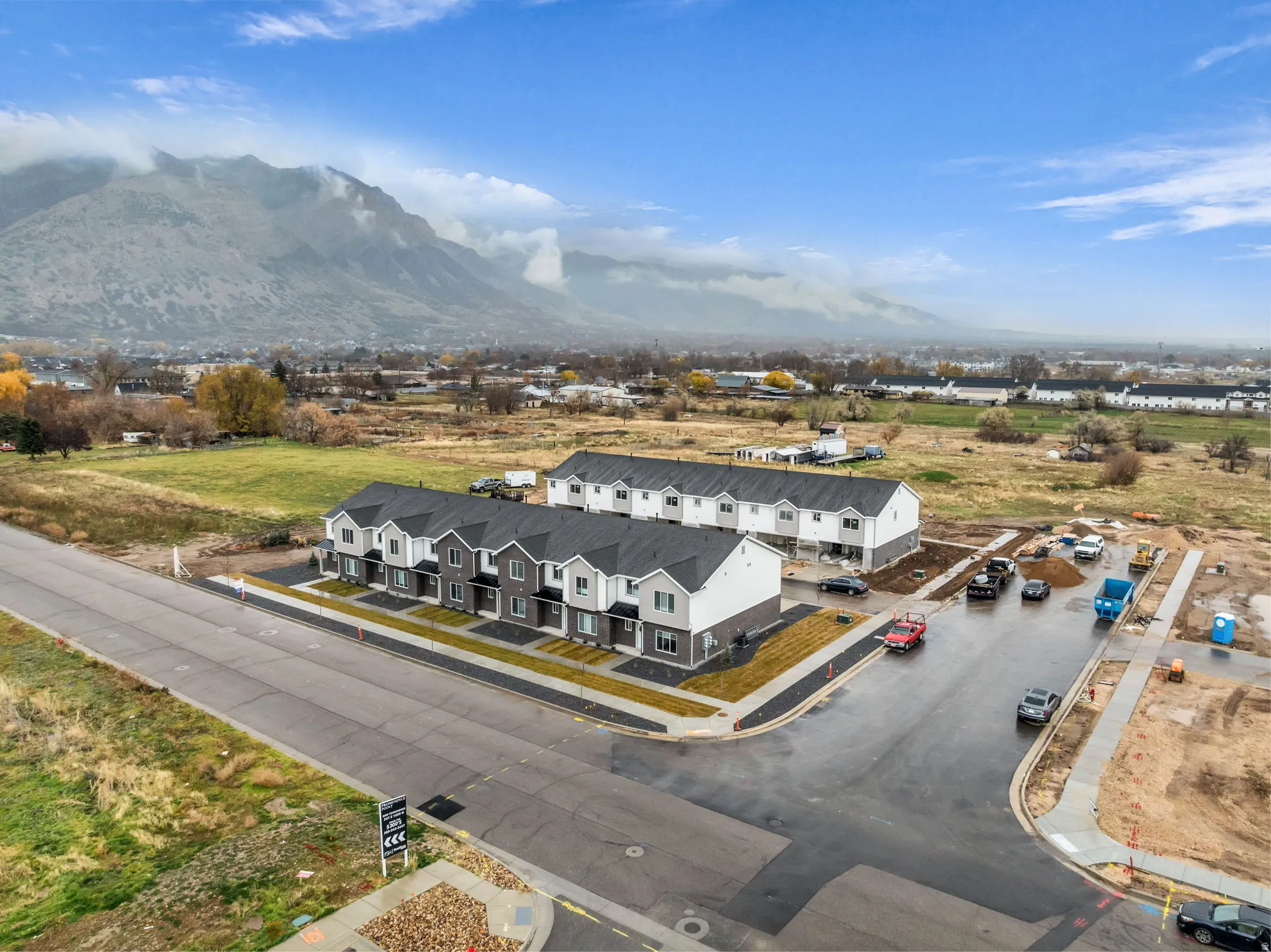 Newly constructed townhome community featuring contemporary architecture and a mountain backdrop