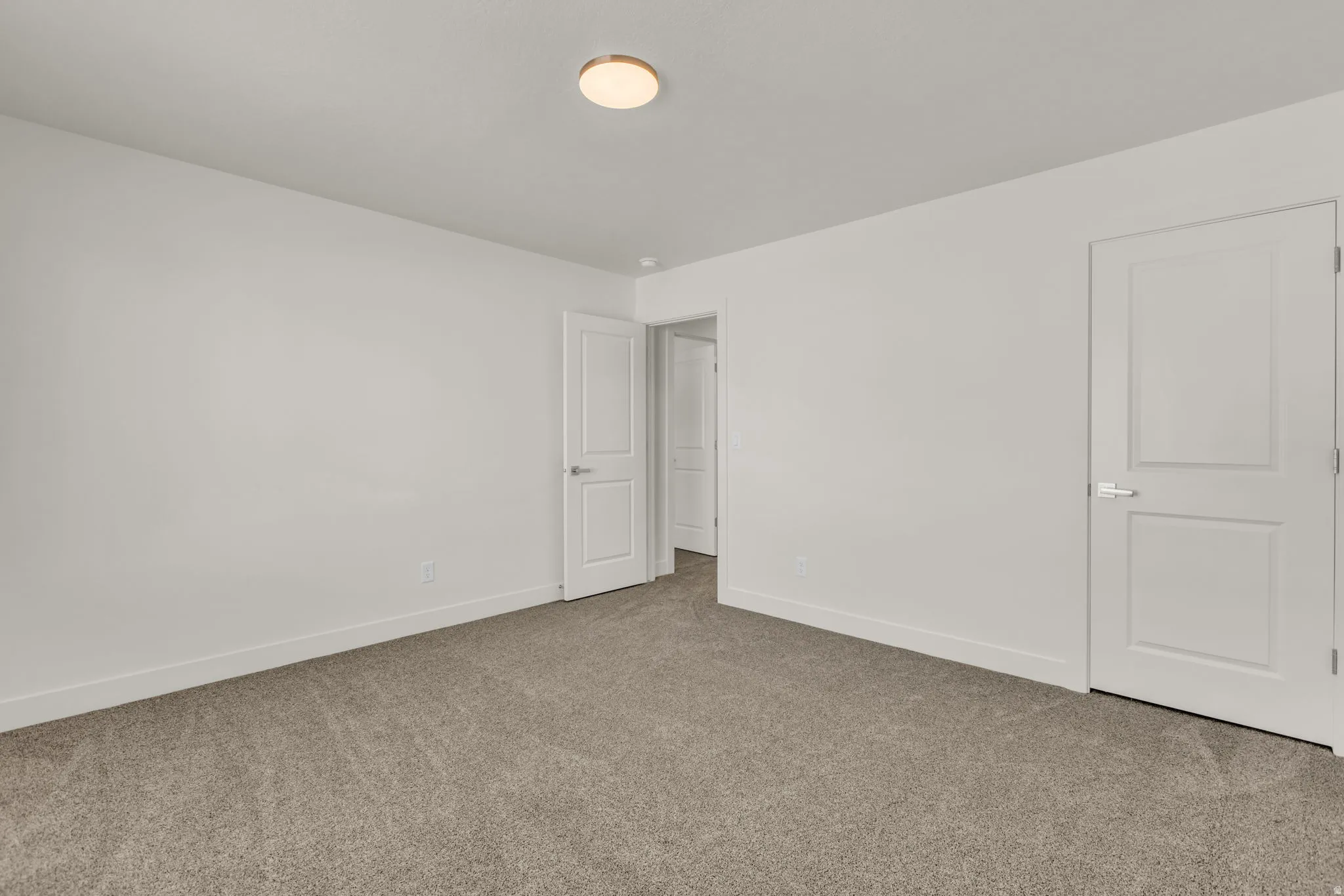 Neutral-toned carpeting paired with white walls