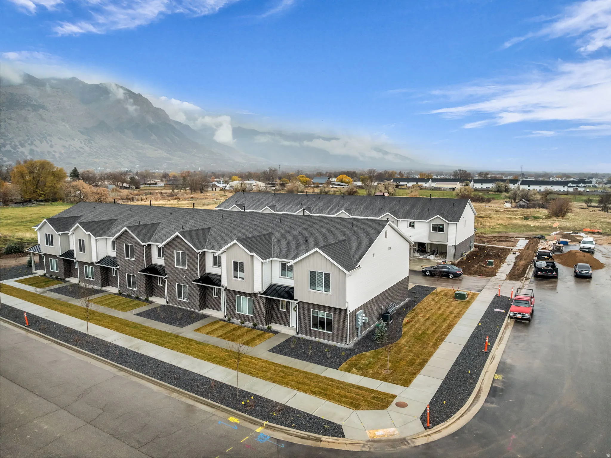 Contemporary townhome exteriors featuring varied siding materials and dark shingle roofing