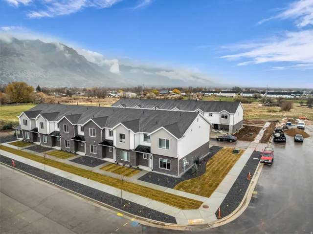 Contemporary townhome exteriors featuring varied siding materials and dark shingle roofing