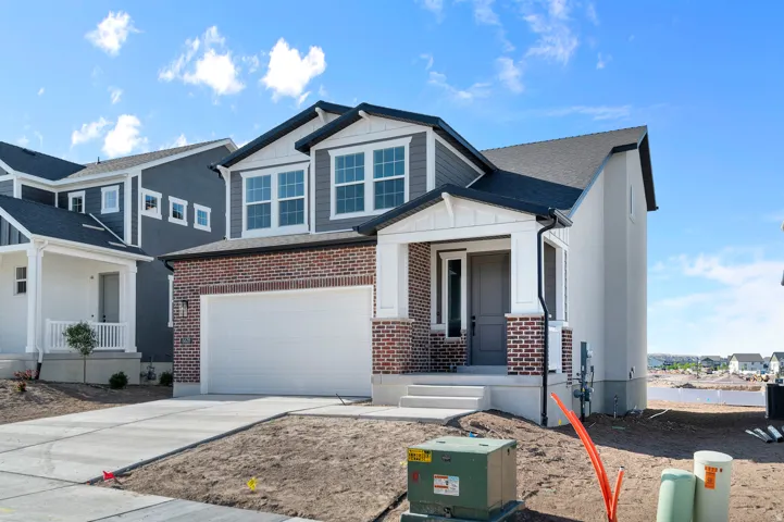 Contemporary residence featuring a brick and siding facade with white trim