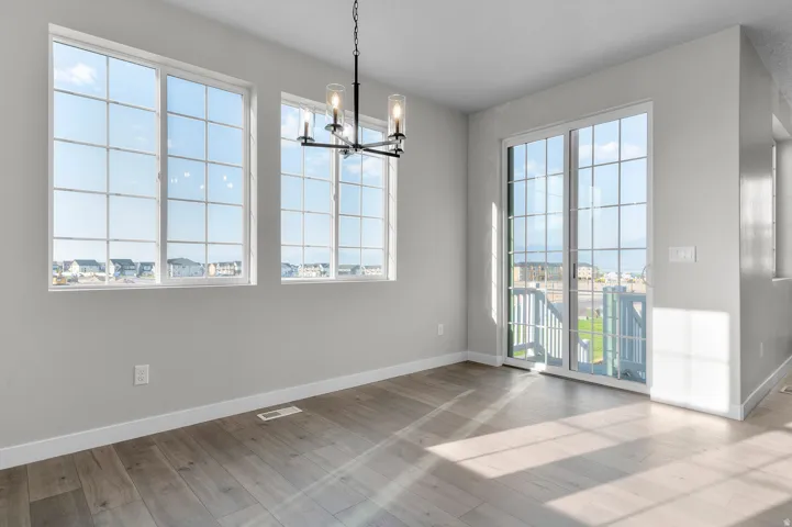 Open-concept interior featuring wood-finish flooring, white baseboards, and light gray walls