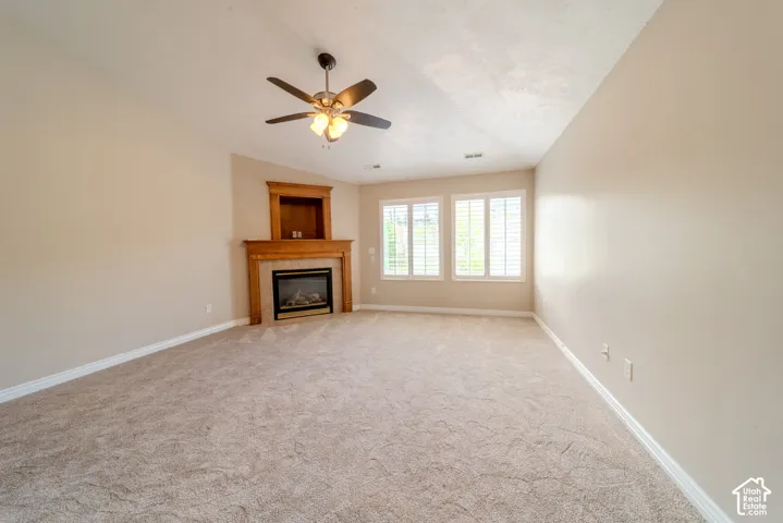 Spacious room featuring neutral carpeting and light beige walls