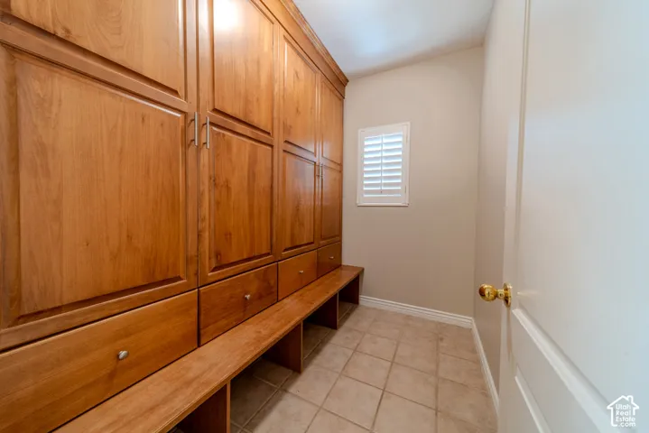 Integrated cabinetry with wood-finish doors and drawers, featuring a built-in bench