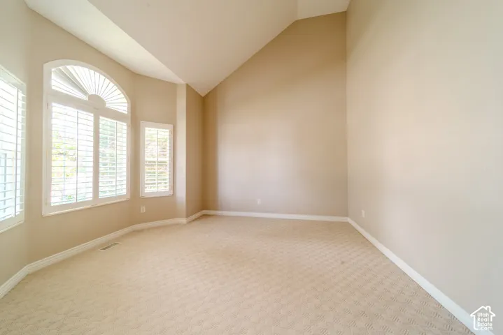 Room featuring a prominent bay window with plantation shutters