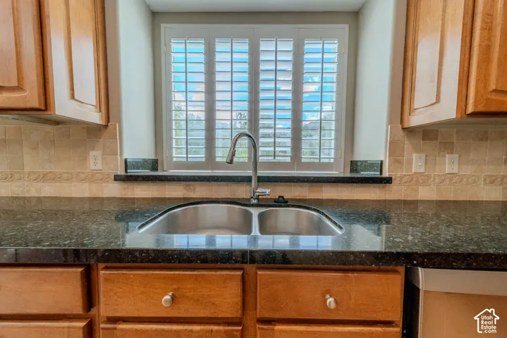 Kitchen sink with a stainless steel double basin, accompanied by a high-arc faucet
