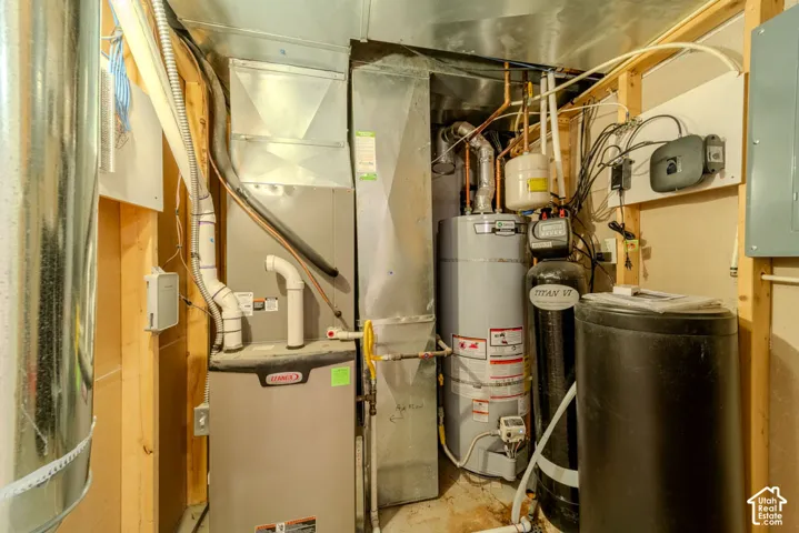 Dedicated utility area featuring a Lennox furnace, hot water heater, and water filtration system