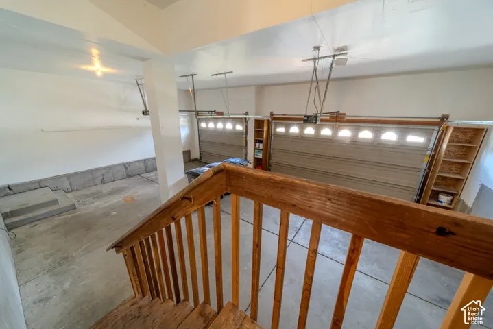 Two-car garage featuring automatic openers and integrated shelving