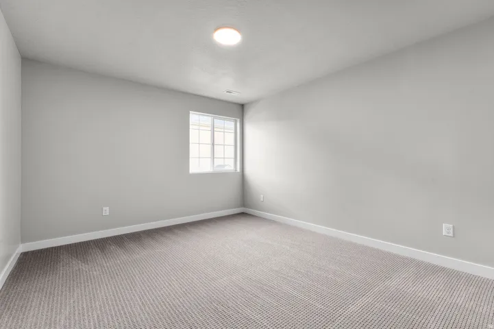 Neutral-toned carpeting paired with light gray walls