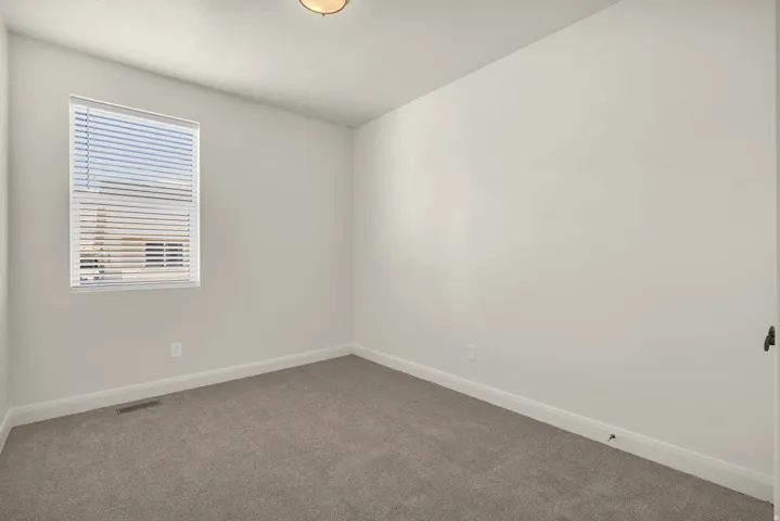 Neutral-toned wall paint and carpeted flooring define this interior space