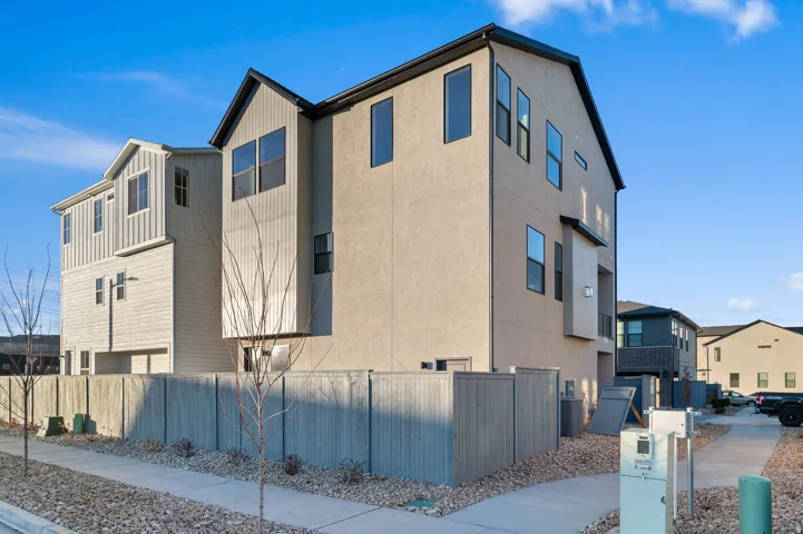 Modern multi-level residence featuring a stucco and vertical siding exterior