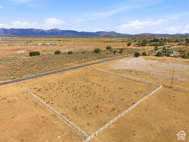 Expansive land parcel featuring a three-rail white fence