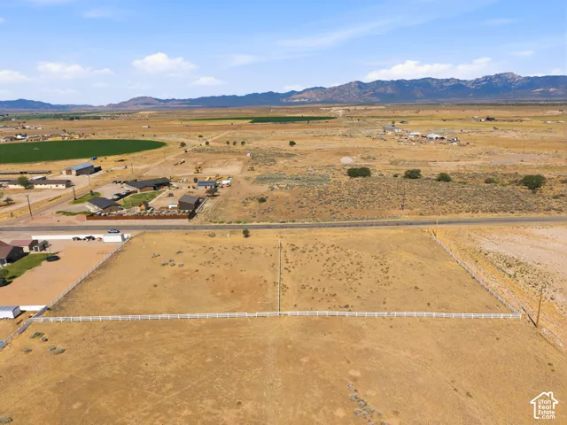 Expansive lot featuring a white fence boundary