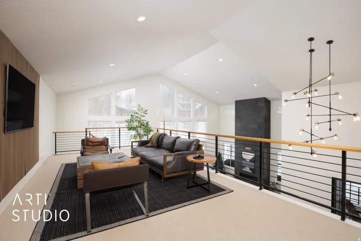 Open loft area featuring a vaulted ceiling and recessed lighting