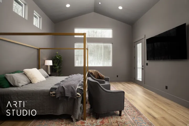 Spacious bedroom featuring a vaulted ceiling and wood-finish flooring