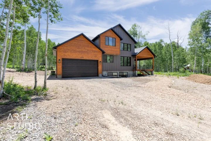 Modern architectural exterior featuring wood-tone and gray paneling