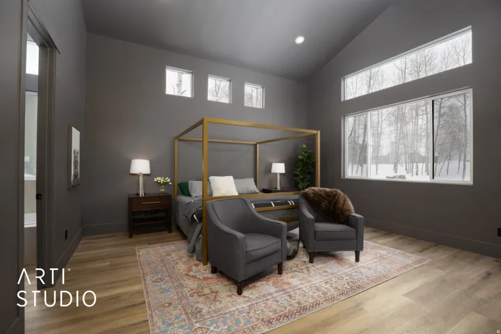 Vaulted ceiling with light wood-finish flooring, featuring multiple tall windows, transom windows, and dark gray walls