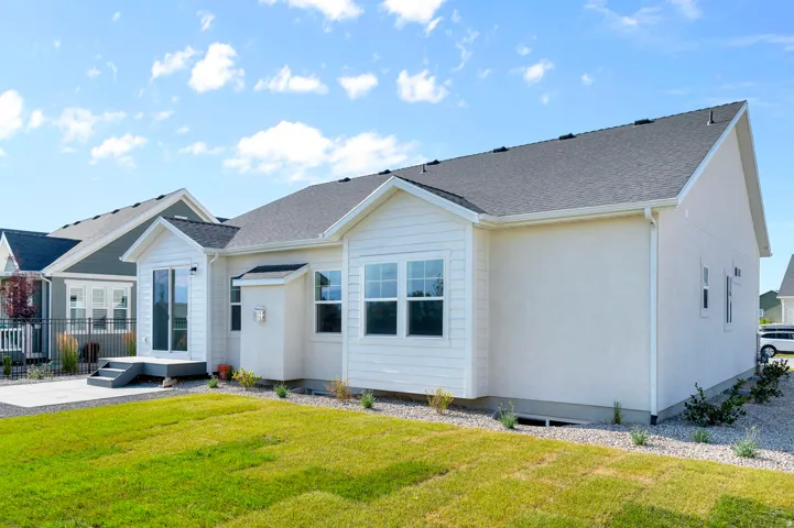 Exterior featuring white siding and stucco finishes